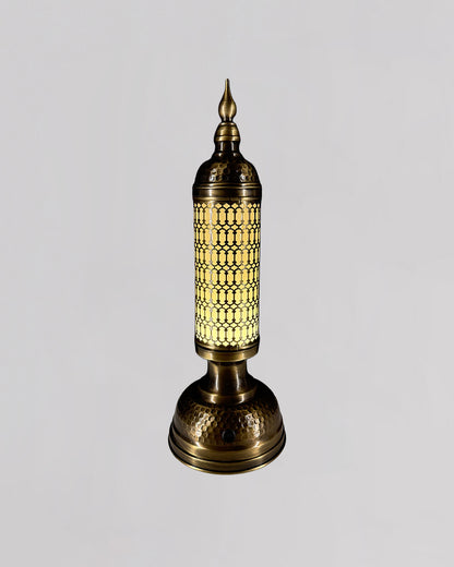 Decorative table lamp with intricate design on a light gray background