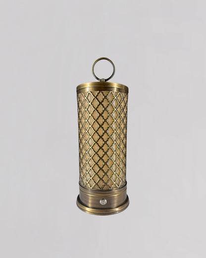 Decorative brass lantern with intricate patterns on a light gray background