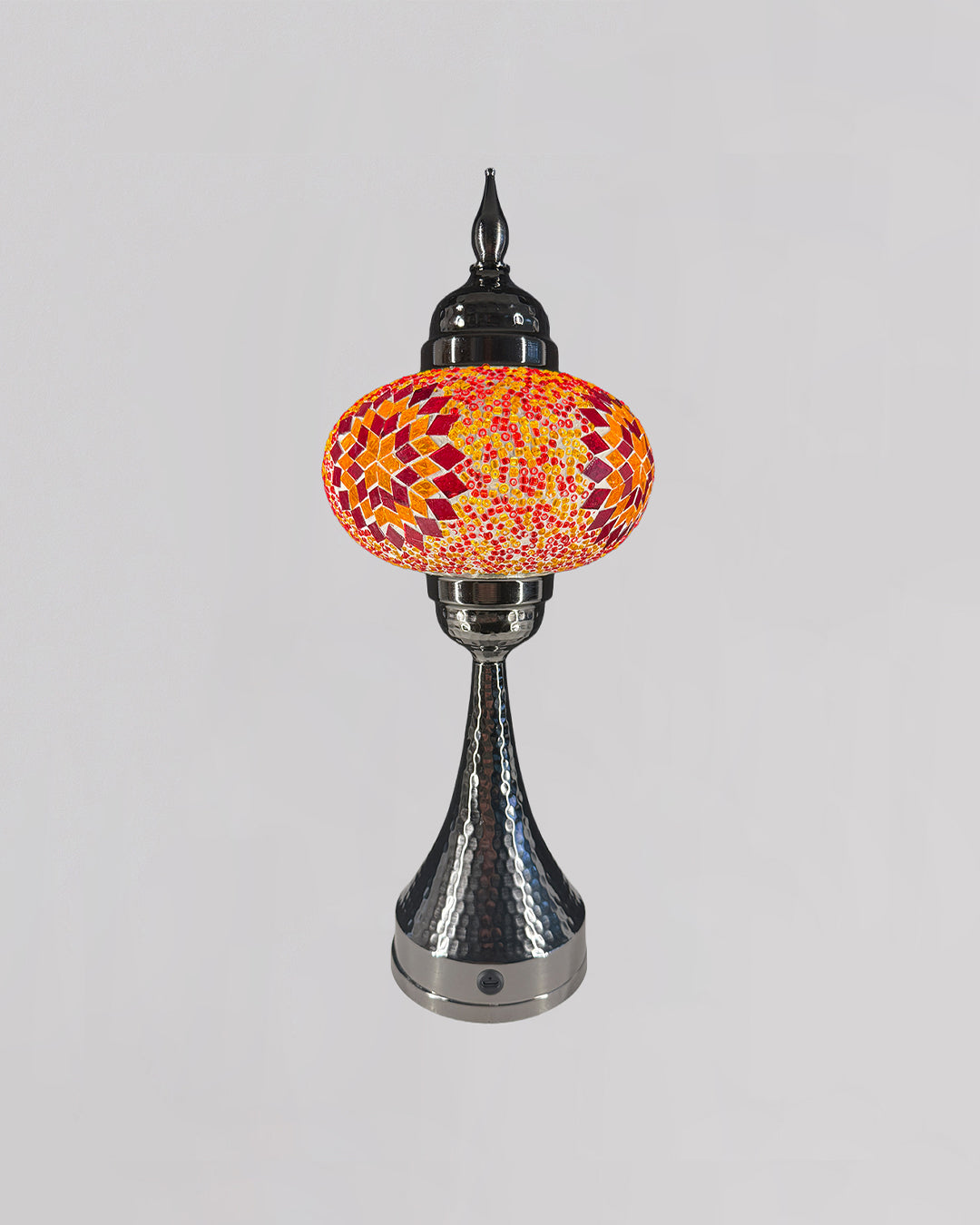 Decorative lamp with a colorful glass shade on a gray background