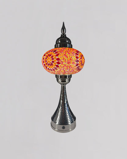 Decorative lamp with a colorful glass shade on a gray background