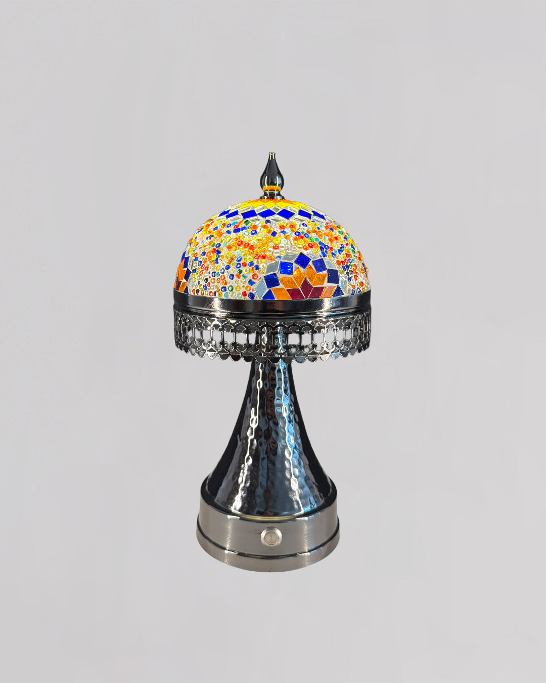 Decorative lamp with colorful mosaic top and metallic base on a gray background