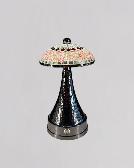 Decorative lamp with a colorful glass shade on a gray background