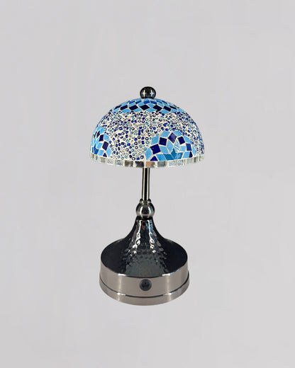 Decorative table lamp with a mosaic blue and silver design on a gray background
