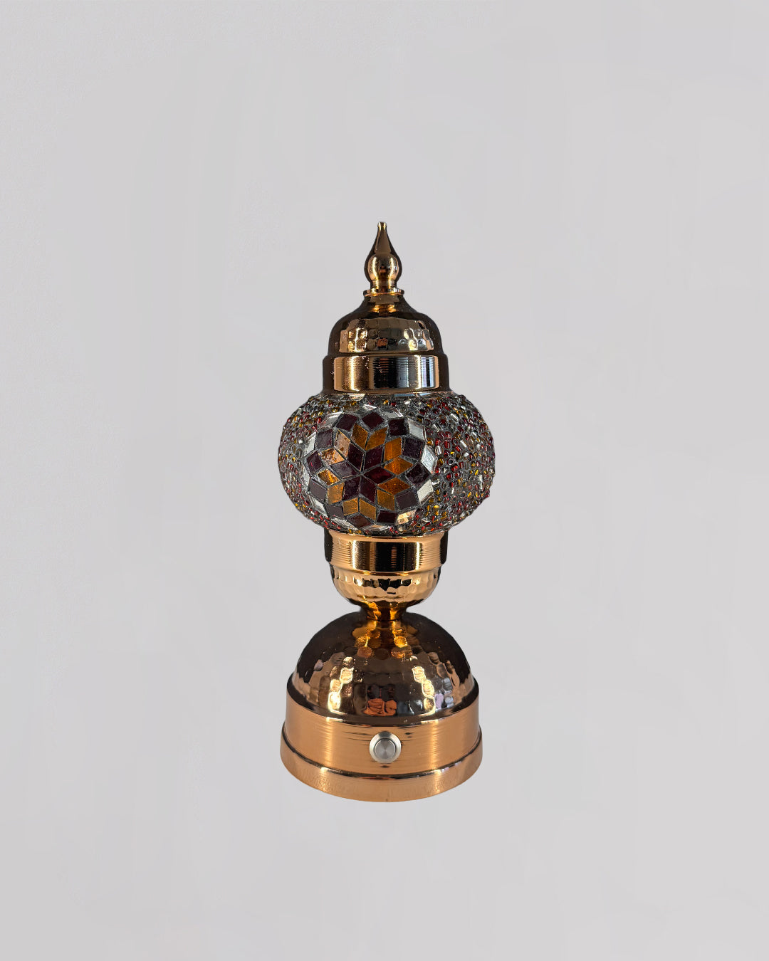Decorative lamp with intricate design on a gray background