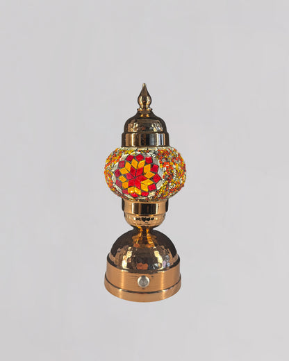 Decorative lamp with a colorful glass shade on a gray background